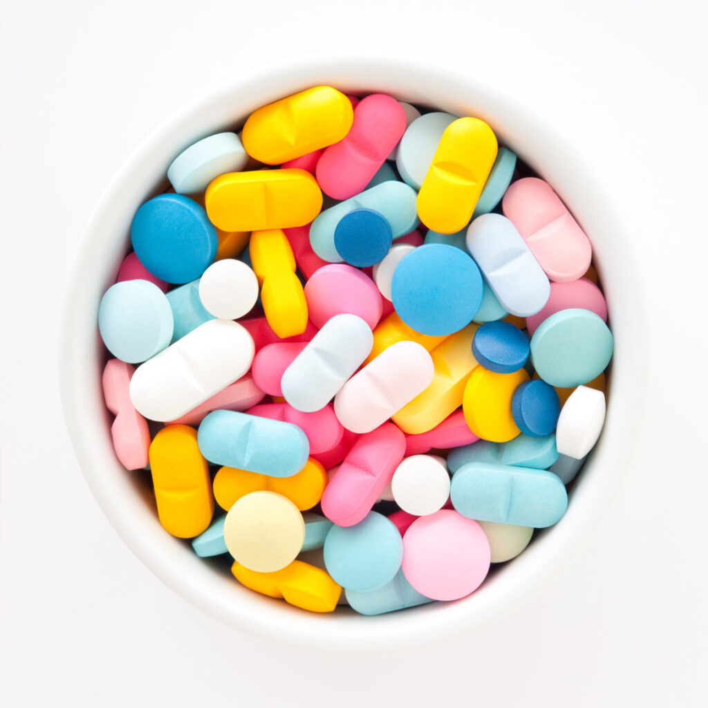 Colorful pills in white bowl
