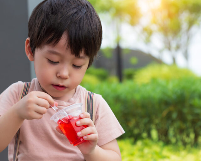 Boy eating red jello