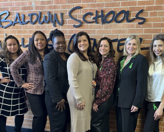 pm pediatric care team standing in front of a brick wall at the baldwin schools wellness center