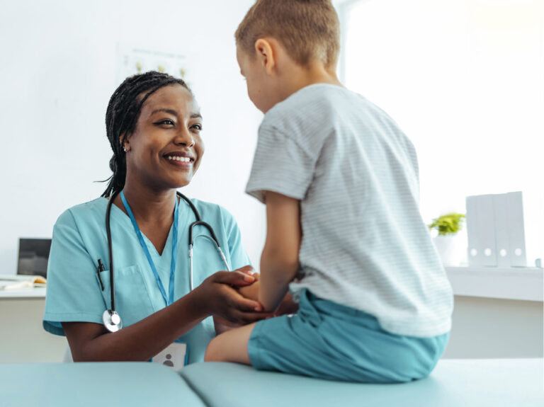 Nurse tending to child in pediatric urgent care setting.