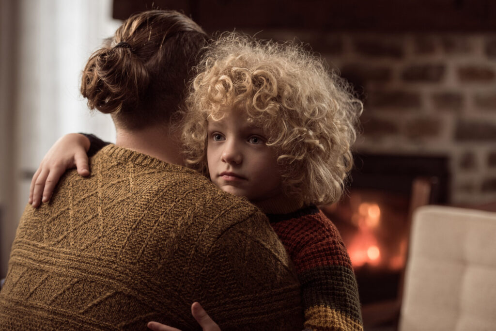Father consoling sad little boy
